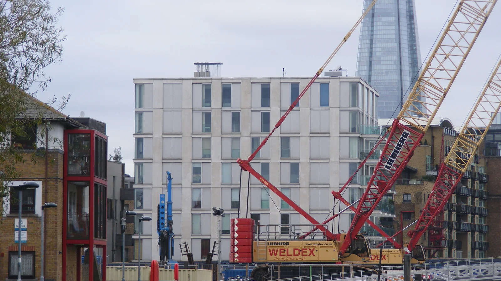 Illustrative sewer construction with crawler crane in London, not a Denver project.